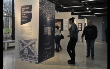 Grupa osób na wystawie, na panelu napis: Rysunki na strzępach życia 