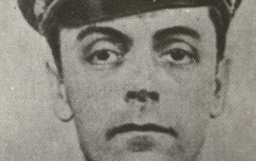 Photo of a middle-aged man in uniform and cap with Nazi symbols