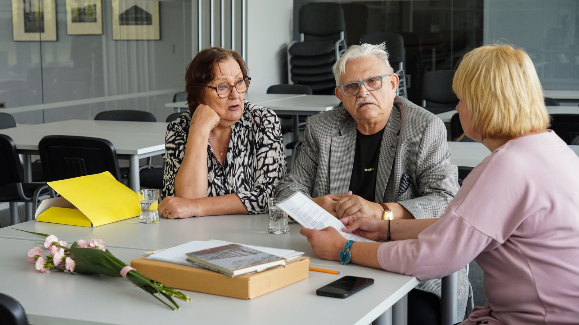Three people sitting at a table.