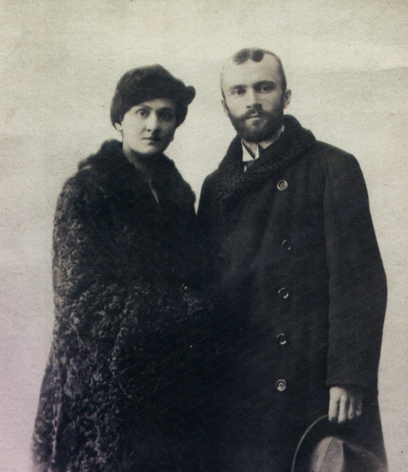 Black-and-white portrait photograph of a middle-aged man, framed from the chest up. He has short hair and faces the camera. He is wearing formal clothing. The background is plain.