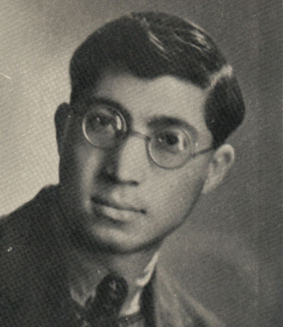 A black-and-white portrait photograph of a young man, taken from close up. He has short hair, a slim face and is looking slightly to one side. He is wearing a jacket. The background is plain.